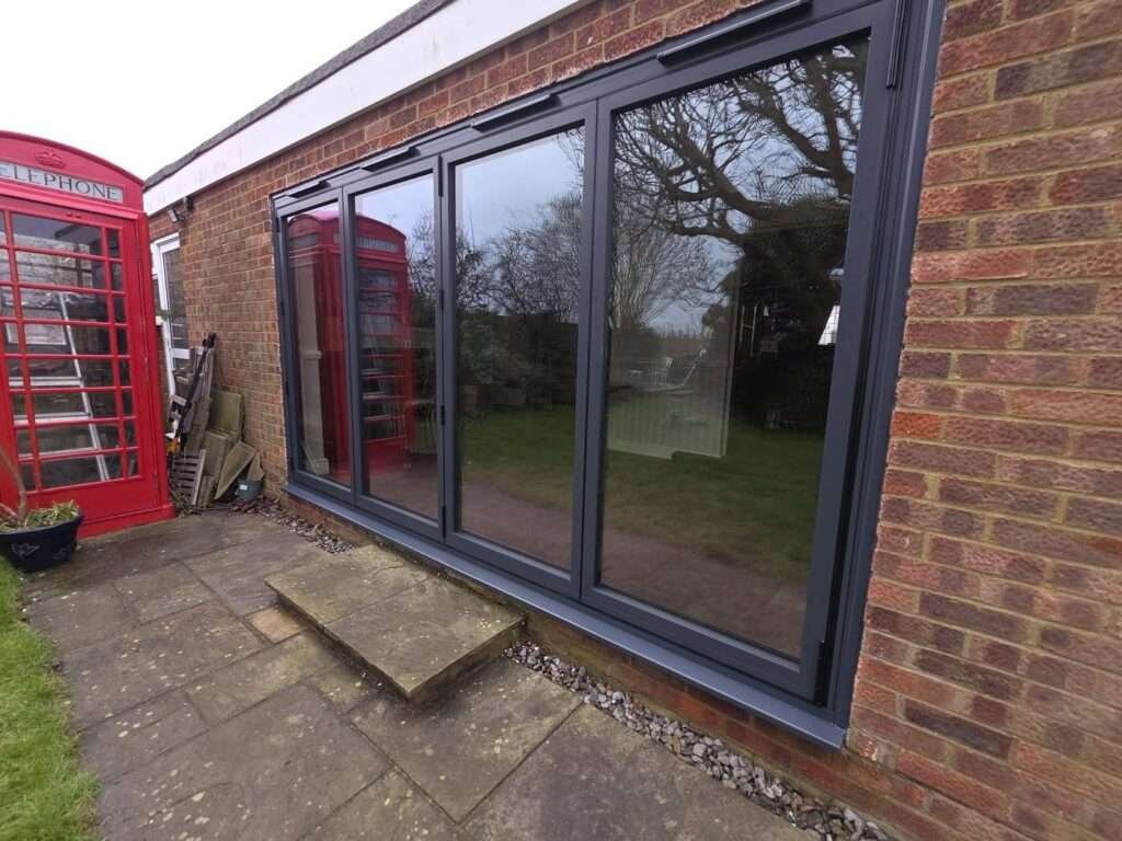 Anthracite grey bifold doors fitted to a single-storey extension