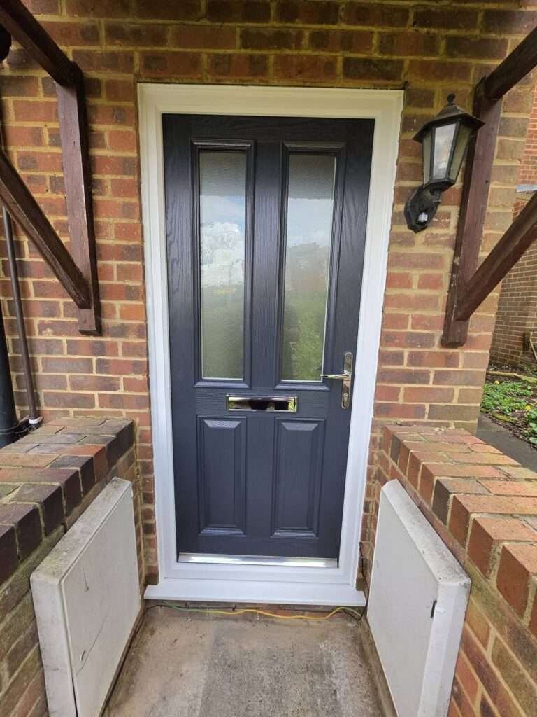 Anthracite composite front door with glazed panels and white frame