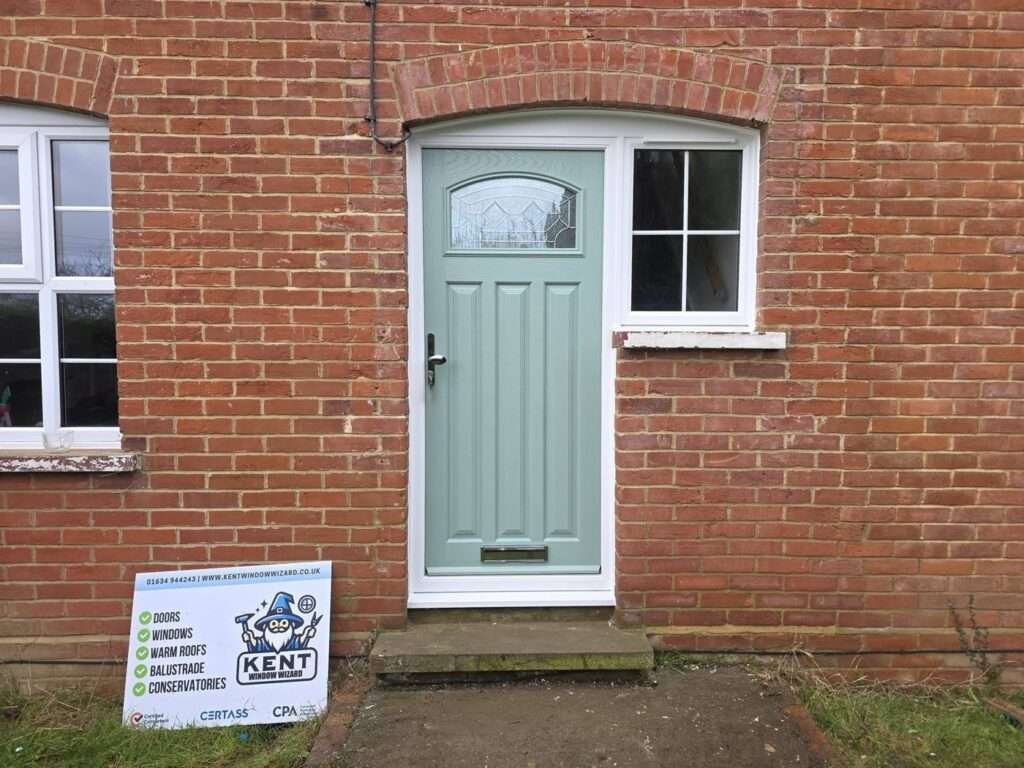 New sage green composite front door and white uPVC side window, after replacement