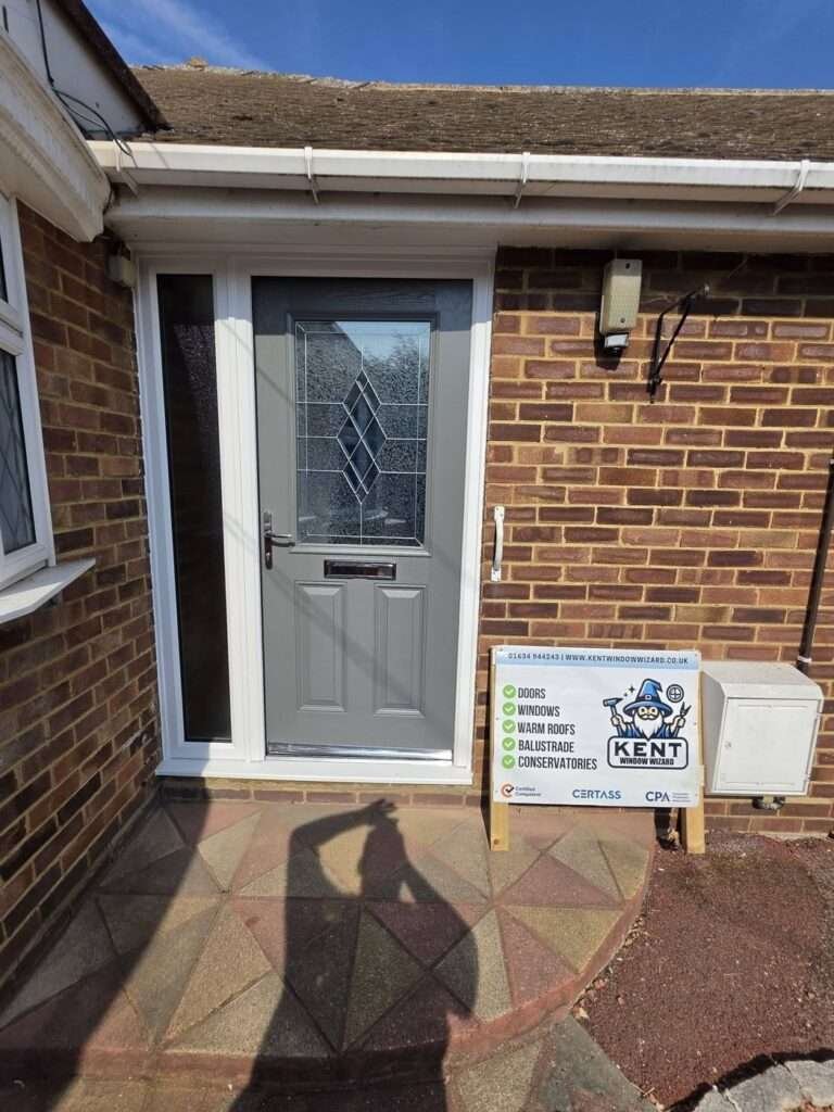 Grey composite front door with leaded glass and side panel