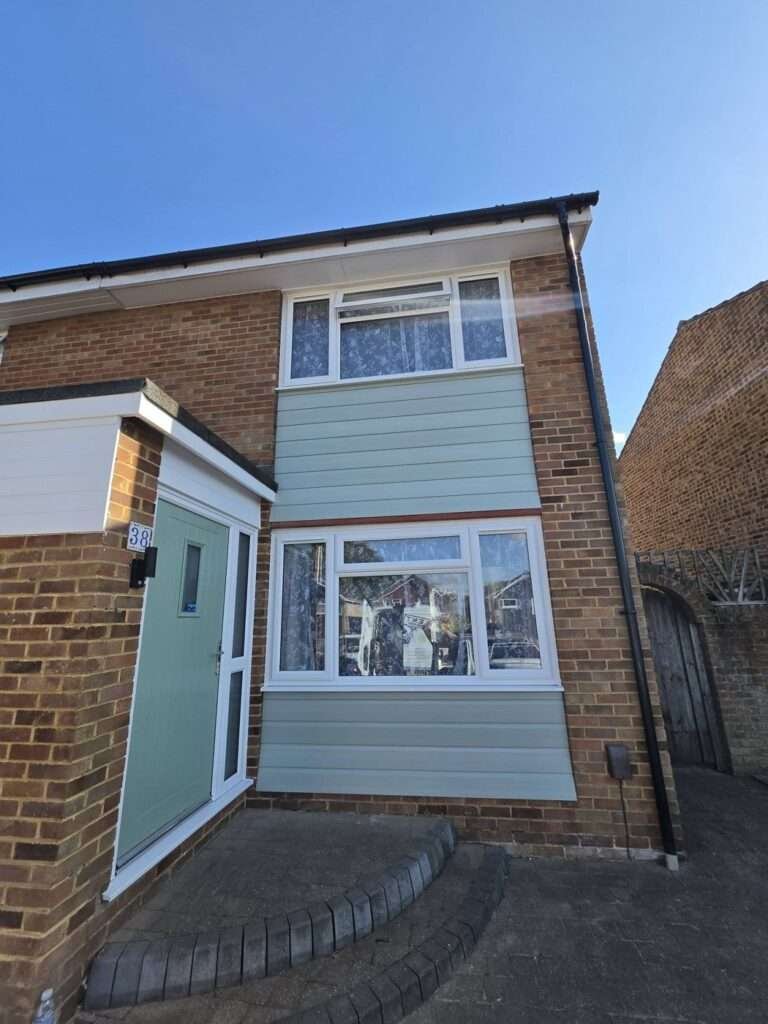 Semi-detached house with new uPVC windows and a sage green composite front door