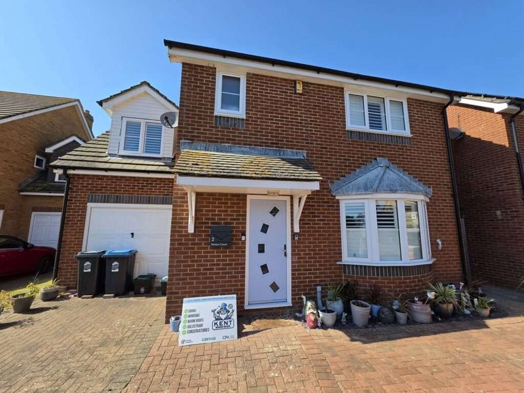 Detached house with a new white composite front door and uPVC windows