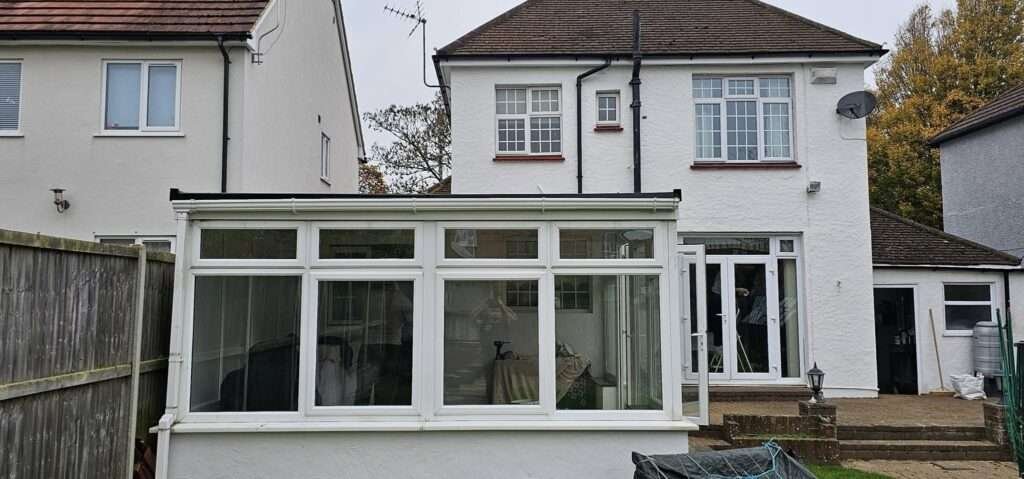 Conservatory with its old glass roof before a warm roof conversion